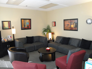 photo sherman oaks office suite 1208, two dark grey sofas, to burgundy chairs, round coffee table