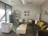 photo sherman oaks office waiting room, white coffee table, brown sofa, white stuffed chair, white file cabinets, wall coverings