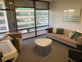 photo sherman oaks room 4, tan coffee table, large windows, brown sofa, brown chair