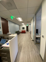 photo sherman oaks office waiting room, view down hall, burgundy sofa at end of hall, reception desk